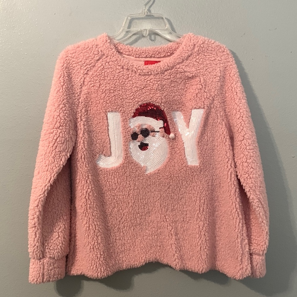 A pink Christmas sweater with a cute sequined phrase saying JOY & Santa figure.